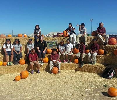 Group of happy students at a pumpkin patch